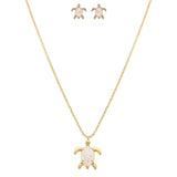 The A-Train Gold White Opal Gem Turtle Necklace Set includes a matching necklace and earrings, each featuring an opal-like turtle shell on white, crafted with high-quality jeweler’s metals.