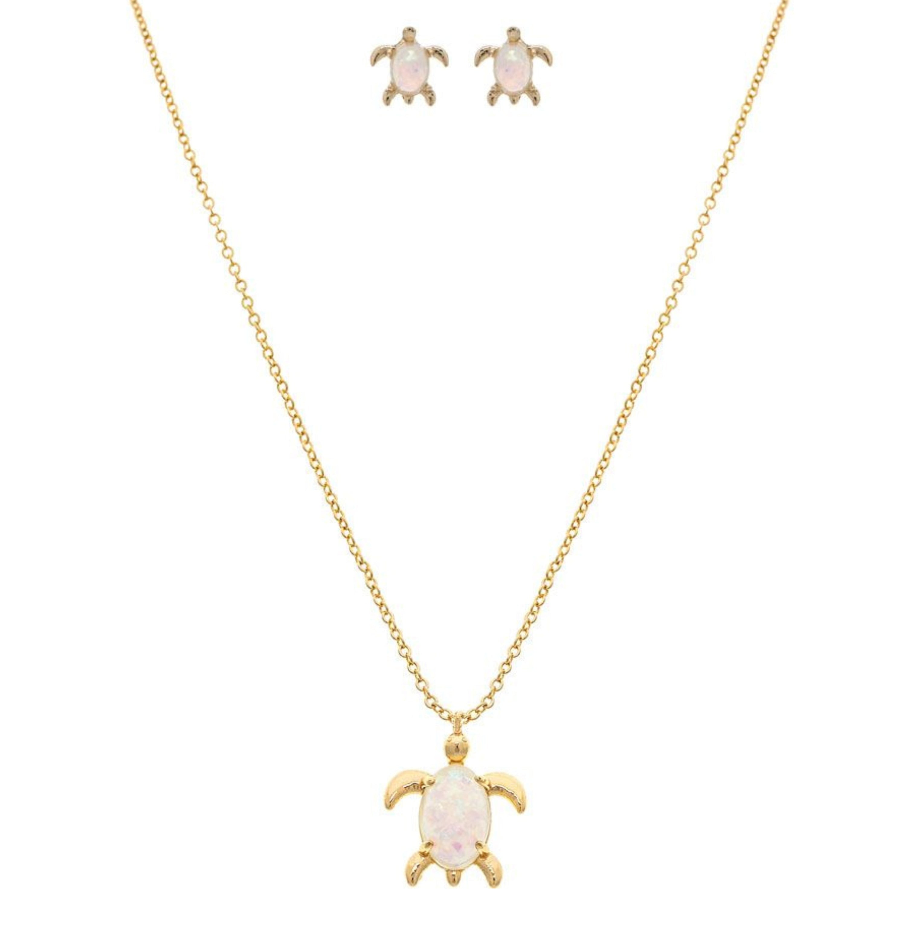 The A-Train Gold White Opal Gem Turtle Necklace Set includes a matching necklace and earrings, each featuring an opal-like turtle shell on white, crafted with high-quality jeweler’s metals.