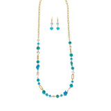 Product Name: Gold Blue Aqua Beach Theme Beads 36" Necklace Set Brand Name: A-Train Rewritten Sentence: The A-Train Gold Blue Aqua Beach Theme Beads 36" Necklace Set features a stunning necklace adorned with blue and aqua beads paired with matching drop earrings, all beautifully displayed on a white background.