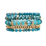 A-Train's Gold Blue Mixed Glass Bead Five Piece Bracelet Set showcases a chic arrangement of faceted and round glass beads in various shapes and sizes, featuring elegant blue and gold tones. Beautifully layered against a white background, this sophisticated bracelet set is perfect for elevating any ensemble.