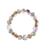 Introducing the A-Train Gold Multi Metal Fire Polished Clear Bead Bracelet—a striking accessory crafted with irregular, translucent, multicolored beads in shades of purple, green, and gold. Strung together in a circular design, this bracelet catches the light beautifully for a stunning effect.