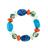 A-Train’s Blue Orange Bead Ceramic Flower Bracelet features an eye-catching array of large blue, green, orange, and multicolored ceramic beads arranged in a circle on a white background, making it a vibrant and elegant accessory that adds a playful touch to any outfit.