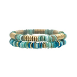 Introducing the Gold Blue Shell Row Beads Two Piece Bracelet Set by A-Train. This elegant jewelry set features two stacked bracelets with round, flat beads in shades of turquoise, blue, and gold, artfully arranged in a repeating pattern on an elastic band. Perfect for adding a touch of sophistication to any look, this set makes a stylish addition to your accessory collection.