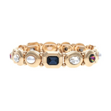 Introducing the A-Train Gold Mixed Cabochon Gems Shapes Bracelet—a stunning accessory featuring alternating round and hexagonal settings adorned with pearls, vibrant multicolor cabochon gems, and sparkling crystals in blue, white, and iridescent hues. This versatile bracelet is the perfect jewelry choice for any occasion.