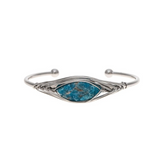 Introducing the A-Train Silver Blue Wire Wrapped Crystal Cuff (Apatite) Bracelet—a stunning adjustable cuff styled with intricate silver wire detailing, an eye-catching blue apatite oval stone centerpiece, and open ends tipped with round silver beads. This elegant piece is perfect for any occasion.