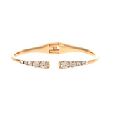 The A-Train Gold Crystal Ends Hinge Cuff Bracelet features an open-front gold design with small round clear crystals set in a row on each end and a secure hinged clasp at the back. This elegant piece of jewelry brings timeless style and sophistication to any occasion.