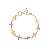 Introducing the A-Train Gold Crystal Cross Link Toggle Bracelet, featuring multiple cross charms—some sparkling with clear crystals—and finished with a stylish toggle clasp. This elegant, adjustable bracelet adds a touch of glamour to any look and perfectly complements your personal style.