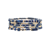 The Gold Blue Natural Stone Beads Five Piece Bracelet Set from A-Train features alternating small gold and dark blue natural stone beads in a stacked, coiled design, displayed against a white background. This versatile accessory effortlessly elevates any outfit.