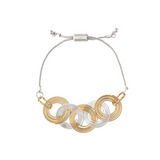 Introducing the A-Train Two Tone Coil Circle Links Chain Top Bracelet—a chic accessory featuring interlocking gold and silver circular links. This bracelet is designed with an adjustable sliding clasp and two delicate spheres at the chain's ends, ensuring a perfect fit every time.