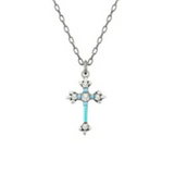 The Dainty Cross Ice Necklace by Firefly is a handmade silver chain necklace featuring a cross-shaped pendant adorned with small, round, clear gemstones and a light blue accent along the vertical bar. This elegant Firefly Jewelry piece adds a touch of sparkle to any look.