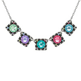 Introducing the Rainbow Medium Square Necklace Soft by Firefly—a handmade piece from Guatemala featuring four square pendants, each adorned with a distinct colored gem in green, purple, blue, and pink. Vibrant multicolored stones encircle each gem on a shimmering silver chain, creating a truly artful accessory by Firefly Jewelry.