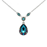 A silver Kensington Large Tear Drop Pendant Necklace - Bermuda Blue featuring a teardrop-shaped pendant surrounded by multicolored crystals, with two rectangular blue crystals on the chain above the pendant.