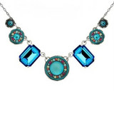 Firefly Kensington Round Ctr 7 Drop Necklace- Bermuda Blue featuring two large rectangular Bermuda blue crystals, a central turquoise cabochon, and smaller circular turquoise and evil eye accents on a silver chain.