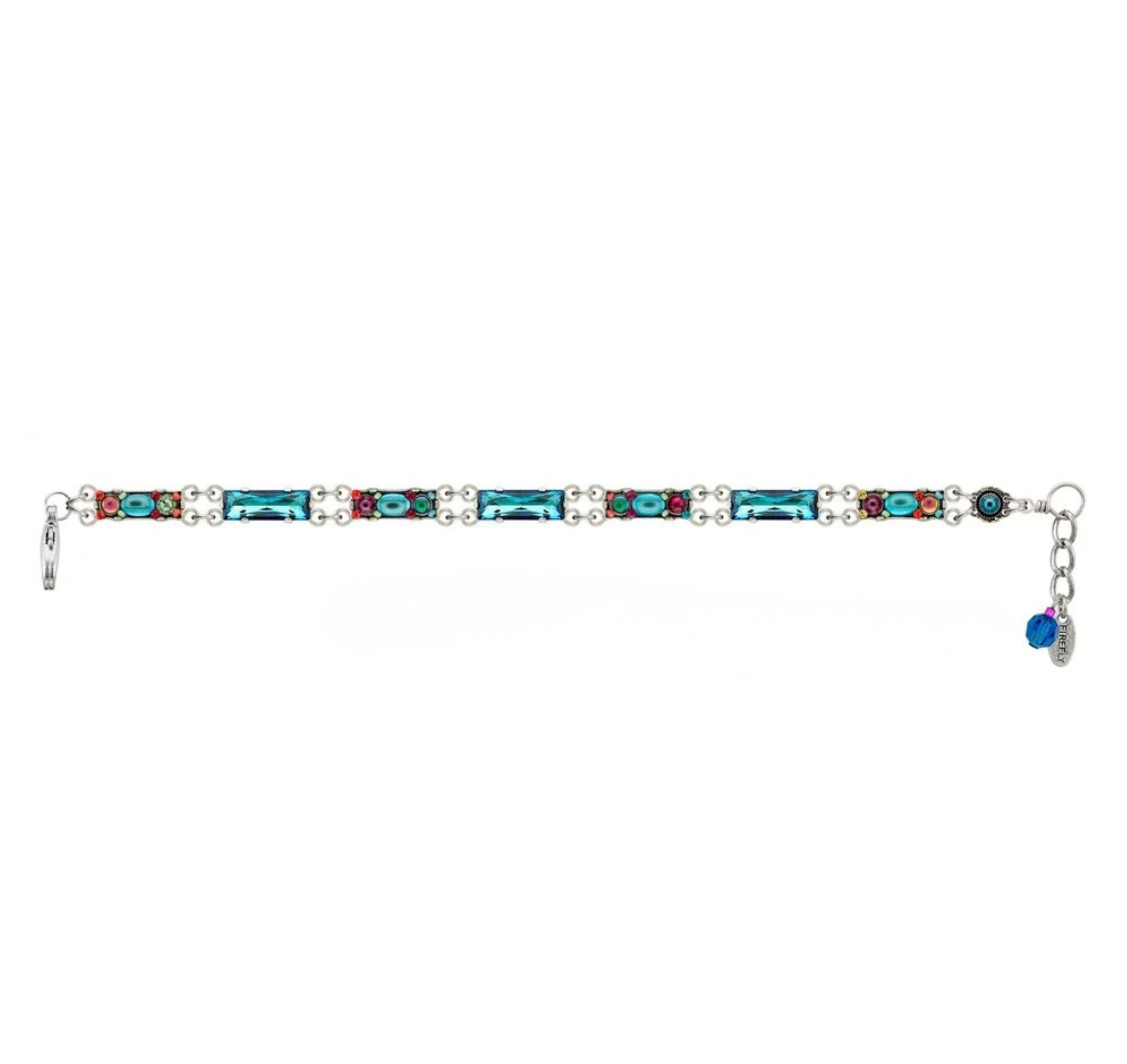 The Firefly Kensington Skinny Bracelet- Bermuda Blue features a silver-tone chain with alternating rectangular blue crystals and clusters of colorful stones, finished with an adjustable link chain and a small blue crystal charm.