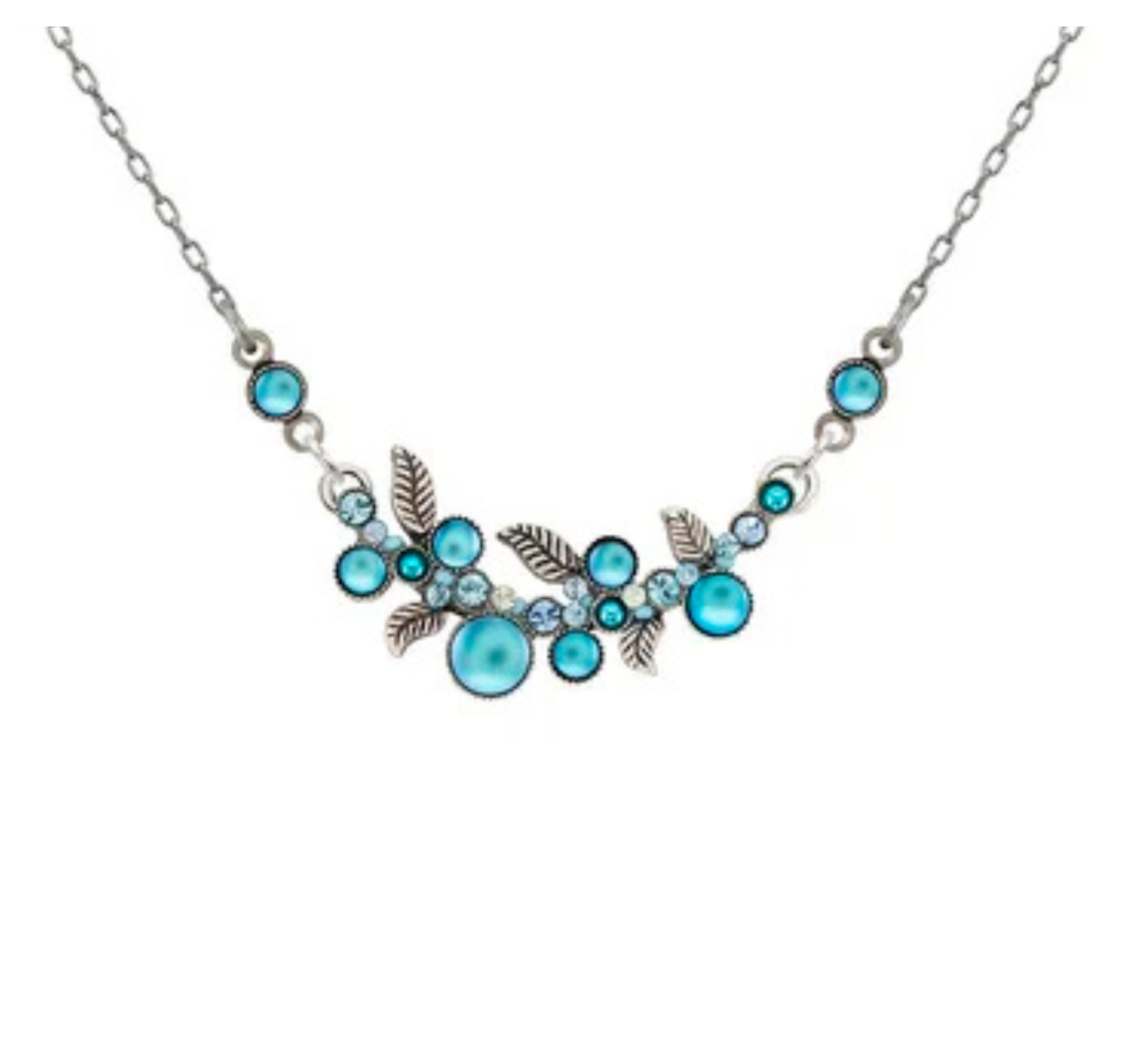 The Moonlight Scallop Necklace Light Blue by Firefly is a fair-trade piece crafted from silver and adorned with light blue gemstones in an intricate floral and leaf motif. This handmade Firefly necklace showcases small and medium blue stones paired with silver leaves on a fine chain, elegantly displayed on a white background.