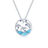The Larimar Three Diving Dolphins & CZ Necklace by Classic of New York features a rhodium-plated sterling silver circular pendant with three dolphins, blue gemstones, and enamel waves on a silver chain.