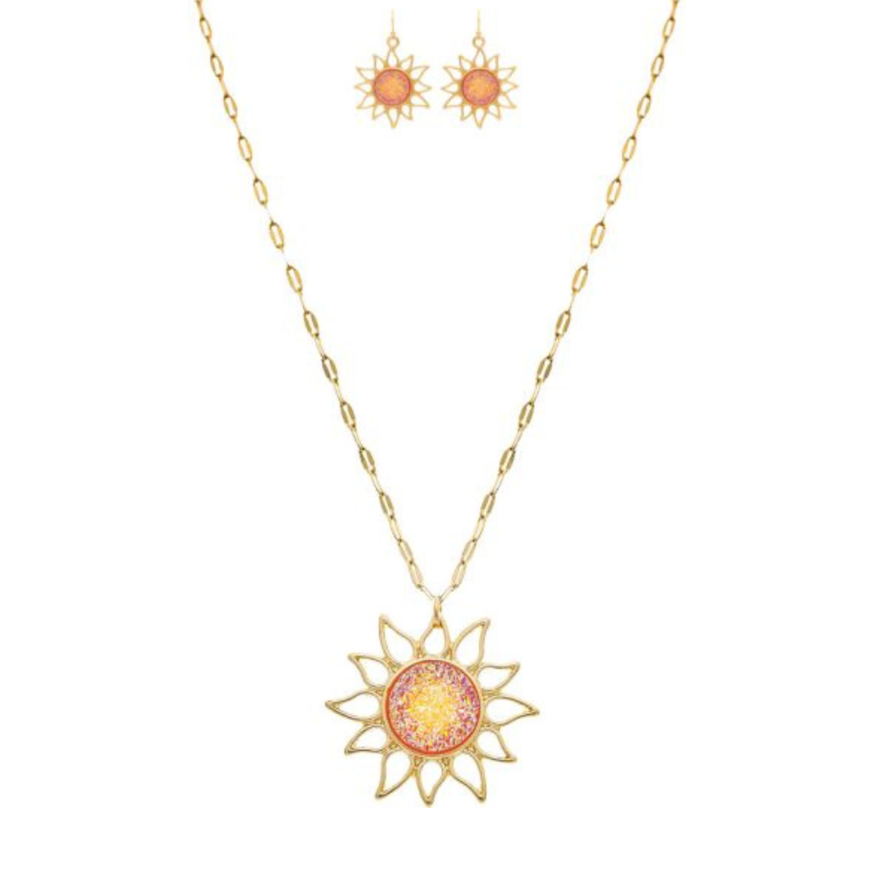 The A-Train Gold Pink/Orange Druzy Sun Necklace Set features a sun-shaped pendant and matching earrings with intricate pink and orange centers, all crafted from mixed jeweler’s metals on a delicate, elongated chain.