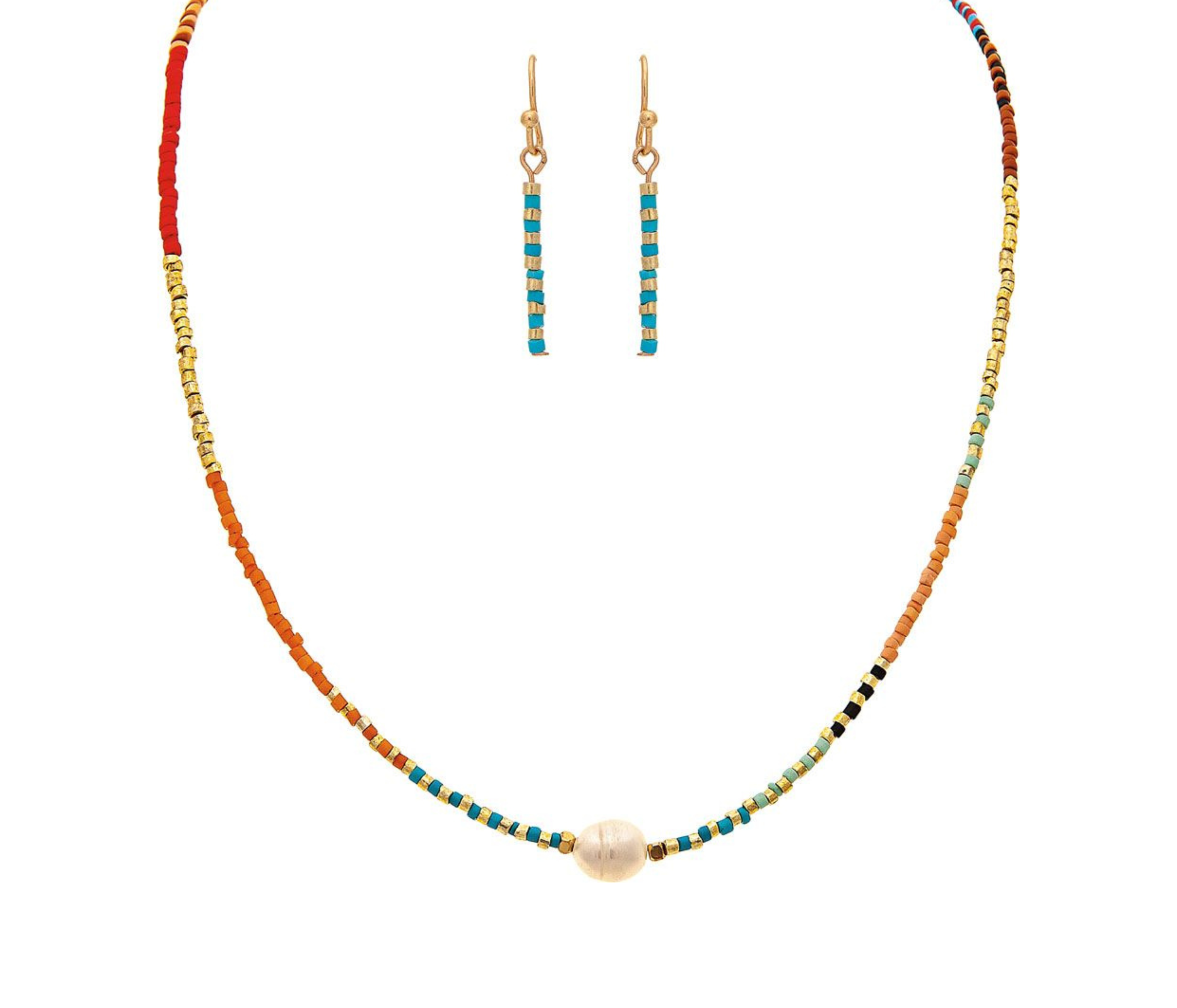 The A-Train Gold Boho Seed Bead Necklace Set features multicolored seed beads and a central pearl, paired with matching necklace and earrings crafted from quality jeweler’s metals, all displayed on a white background.
