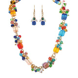 The A-Train Gold Multi Bauble Chunky Bead Necklace Set features a gold chain necklace with bold, colorful bauble beads and matching earrings, perfect for adding vibrant style to any look.