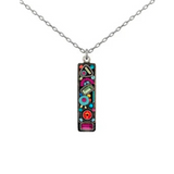 The Calypso Rectangle Multi-Color Pendant Necklace by Firefly features a silver chain and a rectangular pendant adorned with vibrant geometric shapes and patterns in pink, blue, red, and green, exemplifying the exquisite handmade craftsmanship for which Firefly is known.