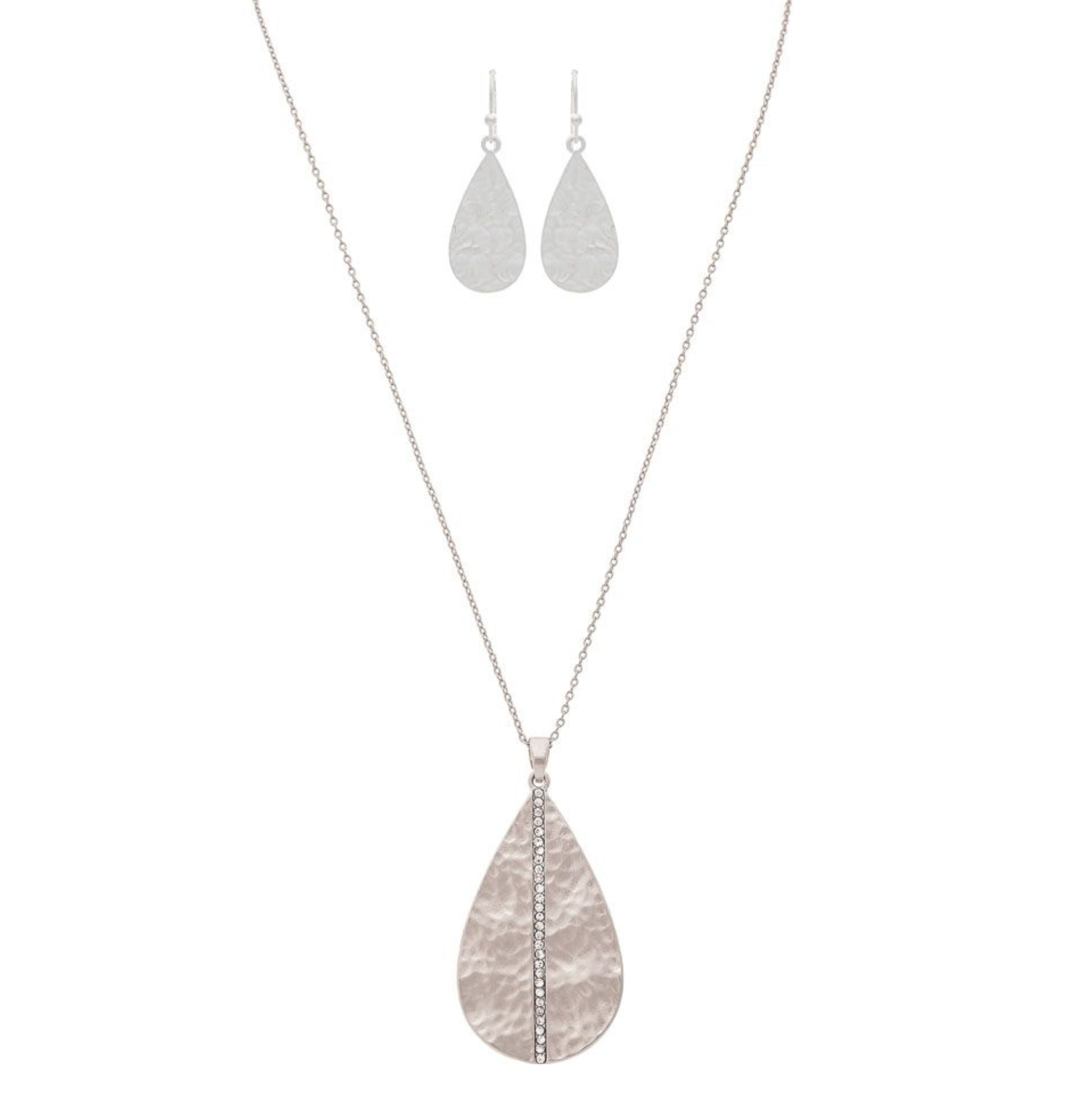 The A-Train Silver Cry Stripe Teardrop Necklace Set includes a long, textured pendant necklace with sparkling crystals and matching hammered teardrop dangle earrings.