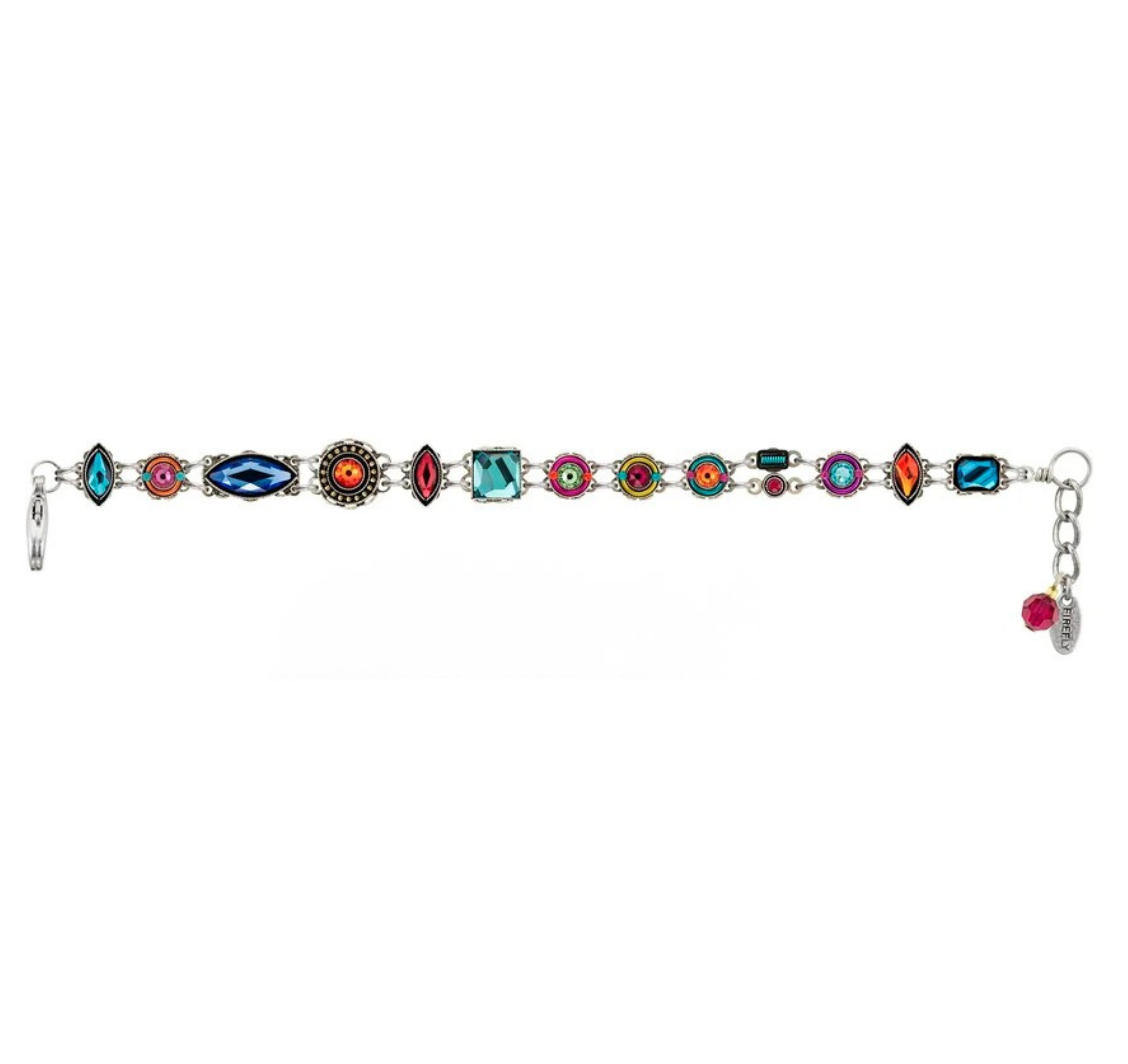 Sure! Here is a rewritten version using the provided product data: The Firefly Architectural Double Line Multi-Color Bracelet features a silver design adorned with colorful, variously shaped gemstones in intricate decorative settings. Inspired by vibrant handmade jewelry from Guatemala, this fair-trade piece includes an adjustable clasp and a petite pink charm at the end, showcasing Firefly's artistry and commitment to ethical craftsmanship.