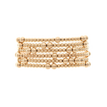 The A-Train Gold Mixed Ball Bead 6 Piece Set Bracelet features multiple rows of small, round gold beads in a stacked design, creating an elegant look against a white background.