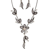 The A-Train Mesh Leaf Flower Black Necklace Set features black mesh and sheer petal shapes with clear crystals, creating an elegant floral design.
