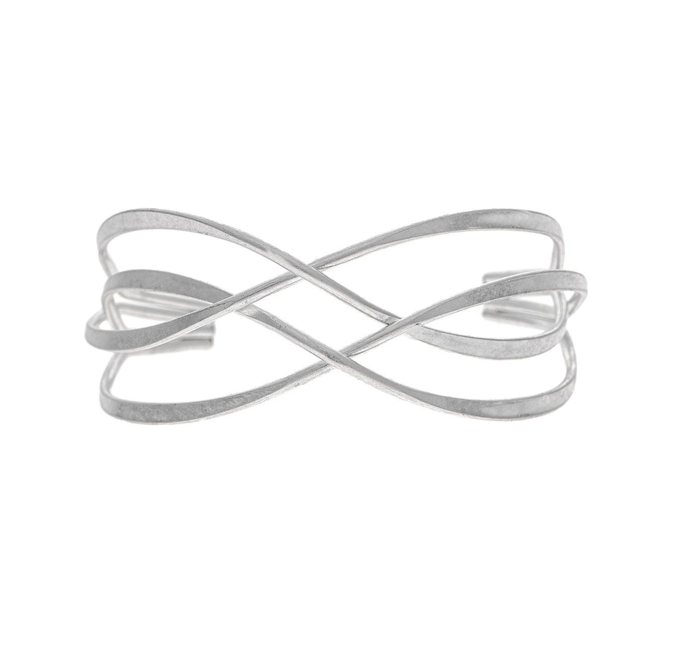 The A-Train Silver Hammered Wire Cuff Bracelet features an open design with two overlapping curved bands forming an abstract infinity symbol, offering adjustable fit and everyday elegance.