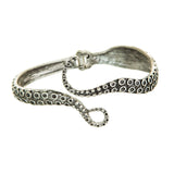 The A-Train Silver Octopus Hinge Cuff Bracelet features a detailed curled tentacle design with suction cup patterns and a secure clasp, displayed against a white background.
