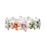 Discover the A-Train Silver Multi-Color Painted Flower Bracelet, crafted from premium mixed metals and adorned with pastel orange, pink, green, and blue flowers with a polished finish and delicate petal details.