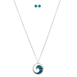 The A-Train Silver Bluewater Inlay Rip Curl Necklace Set features a circular pendant and matching blue stud earrings, elegantly displayed on a white background.