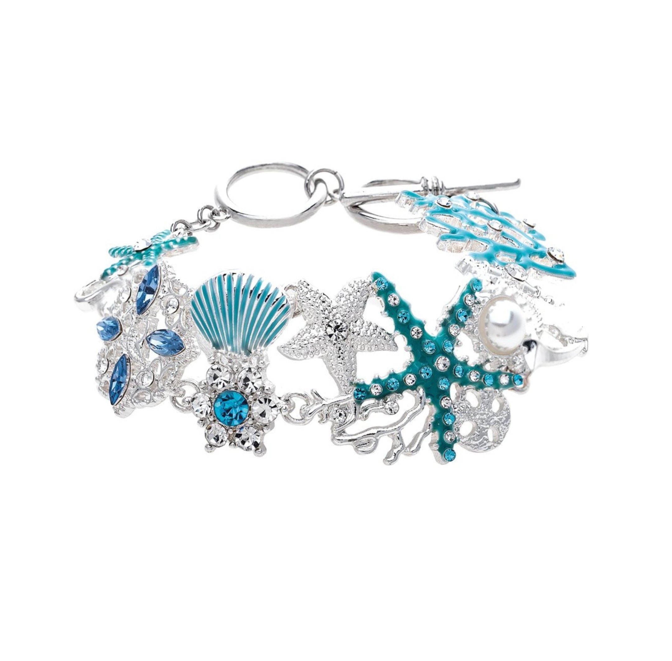 The A-Train Silver Enamel Crystal Seaside Mosaic Toggle Clasp Bracelet features sea-inspired motifs—starfish, seashell, coral, pearls, and sparkling crystals—linked on a delicate silver chain.