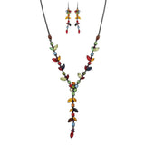 The A-Train Black Multi Jewel Tone Gems Y Drop Necklace Set features a matching necklace and earrings with leaf and round-shaped gems on a dark metal chain for a vibrant, nature-inspired look.