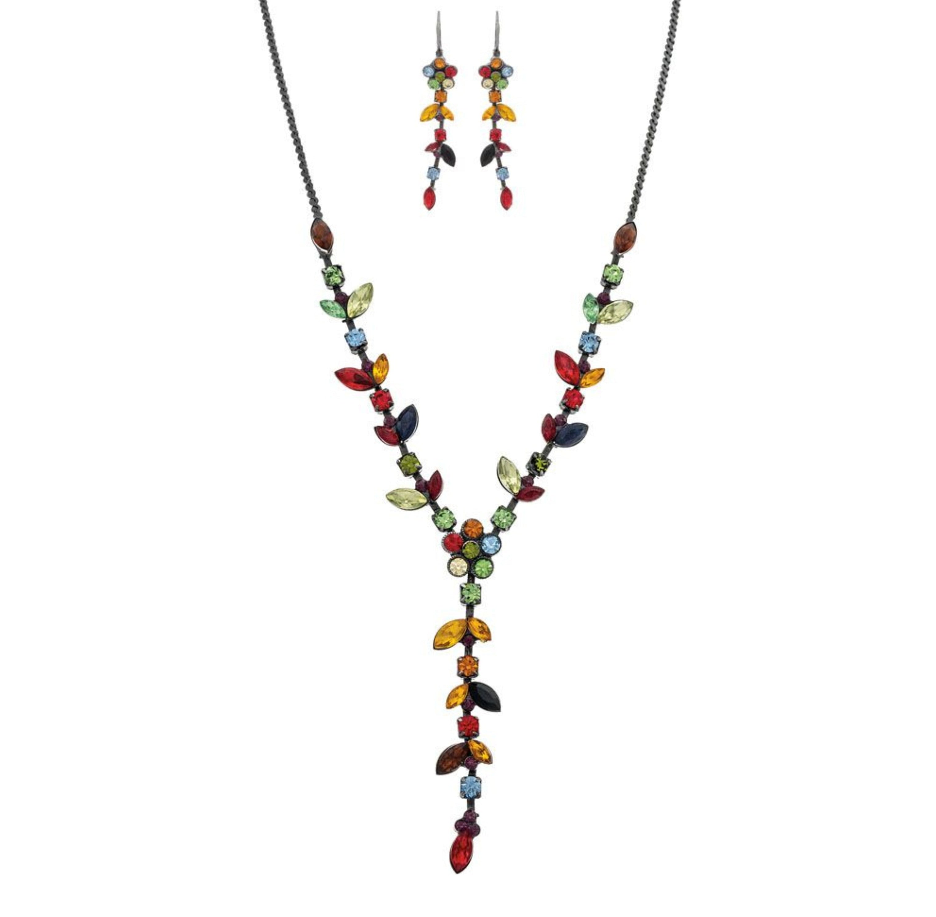 The A-Train Black Multi Jewel Tone Gems Y Drop Necklace Set features a matching necklace and earrings with leaf and round-shaped gems on a dark metal chain for a vibrant, nature-inspired look.