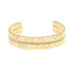 The A-Train Gold Crystal Row Cuff Bracelet features a single row of sparkling white stones set along the center and offers an adjustable fit with its flexible cuff design.