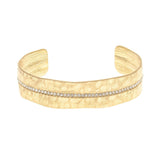 The A-Train Gold Crystal Row Cuff Bracelet features a single row of sparkling white stones set along the center and offers an adjustable fit with its flexible cuff design.