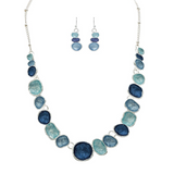 The A-Train Silver Multi-Color Blue & Aqua Wash Concave Circles Necklace Set features alternating blue and aqua concave circles with matching dangle earrings, creating a striking look against a white backdrop.