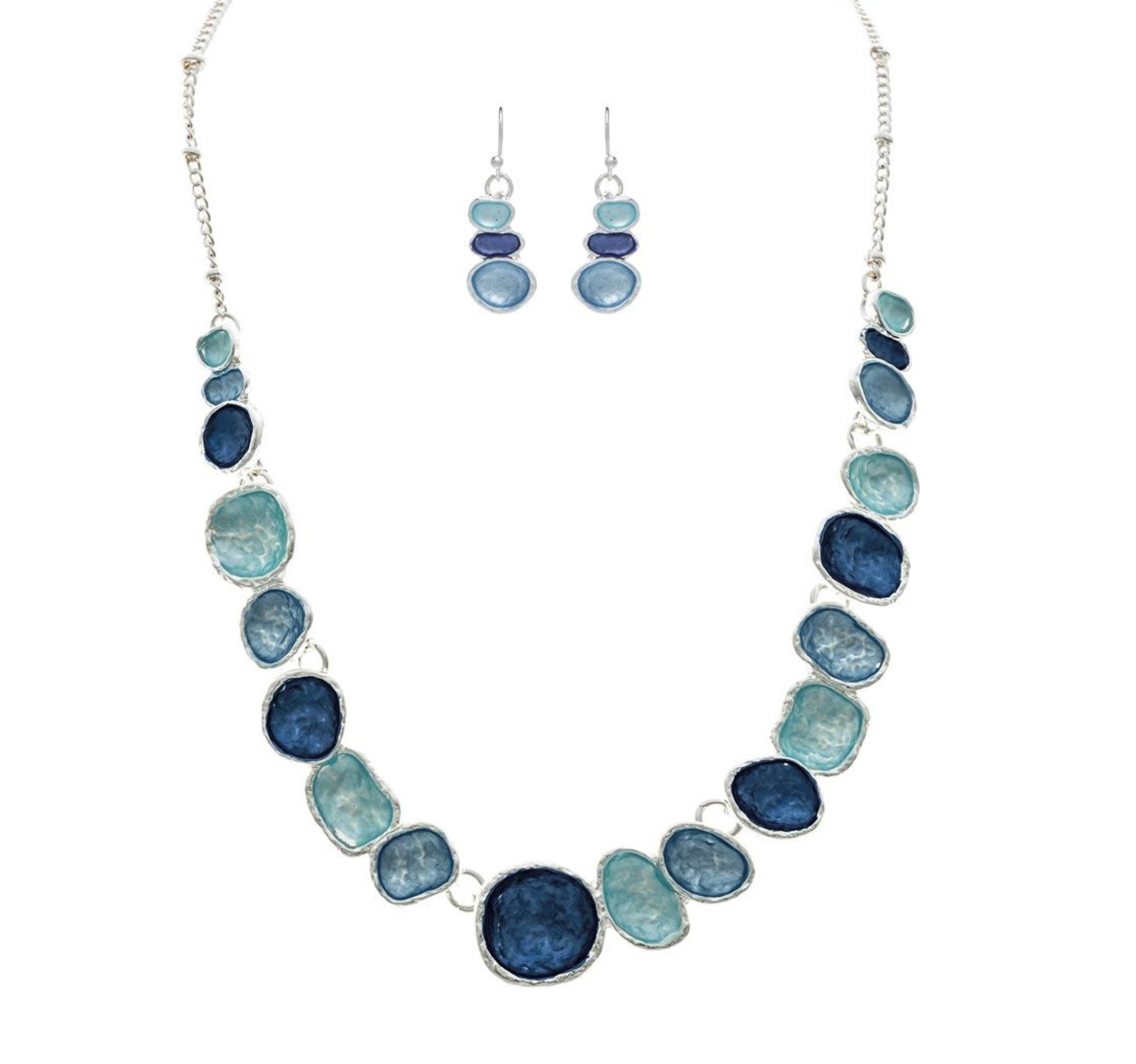 The A-Train Silver Multi-Color Blue & Aqua Wash Concave Circles Necklace Set features alternating blue and aqua concave circles with matching dangle earrings, creating a striking look against a white backdrop.