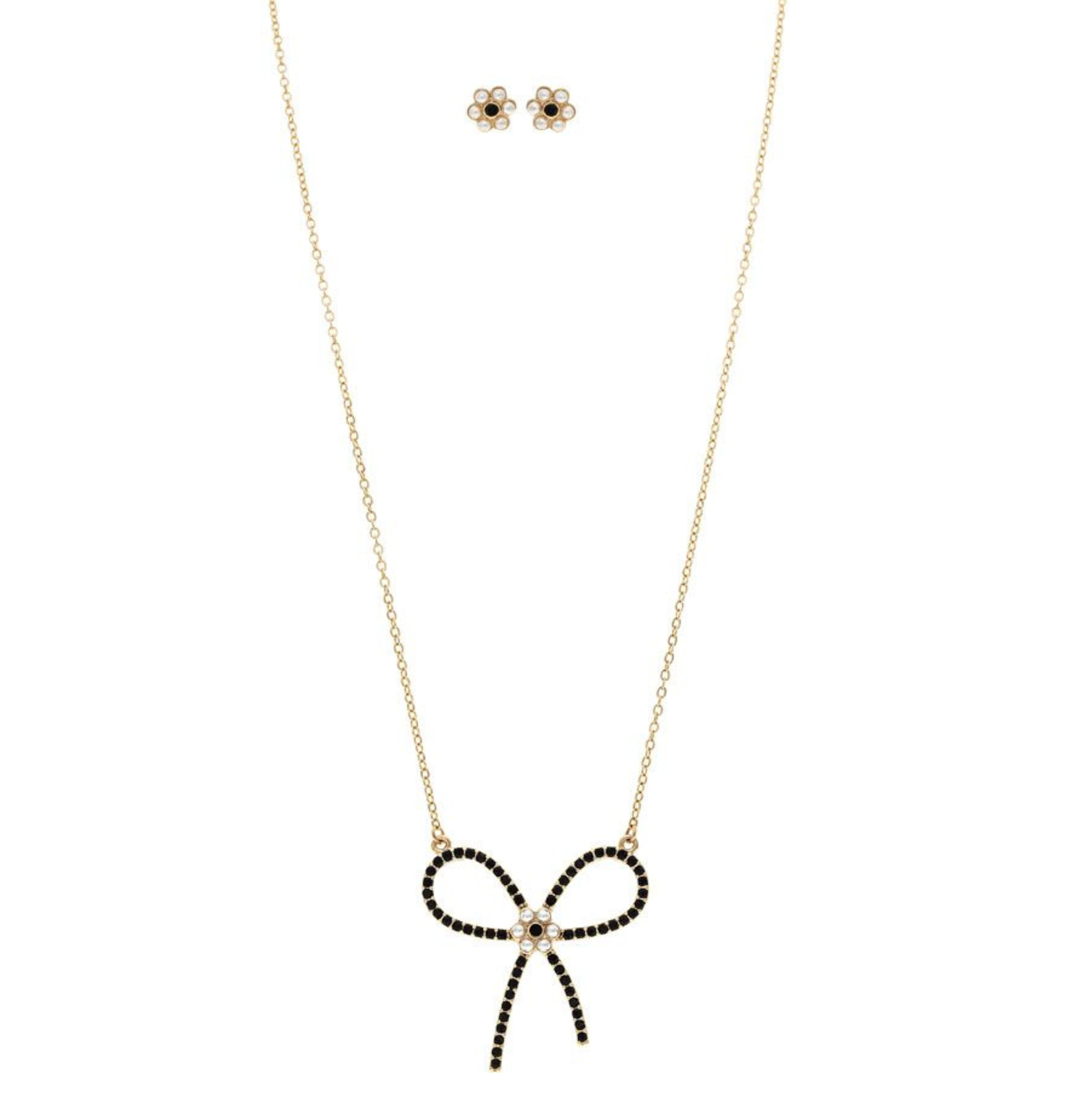The A-Train Gold & Black Pearl Flower Bow Necklace Set features a gold necklace with a black gemstone bow pendant and matching flower-shaped pearl stud earrings, crafted from high-quality jeweler’s metals.