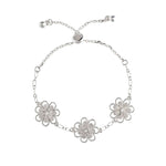 The A-Train Silver Three Flower Chain Link Slide Bracelet features three daisy-shaped charms on a chain and an adjustable sliding clasp with two small end beads for the perfect fit.