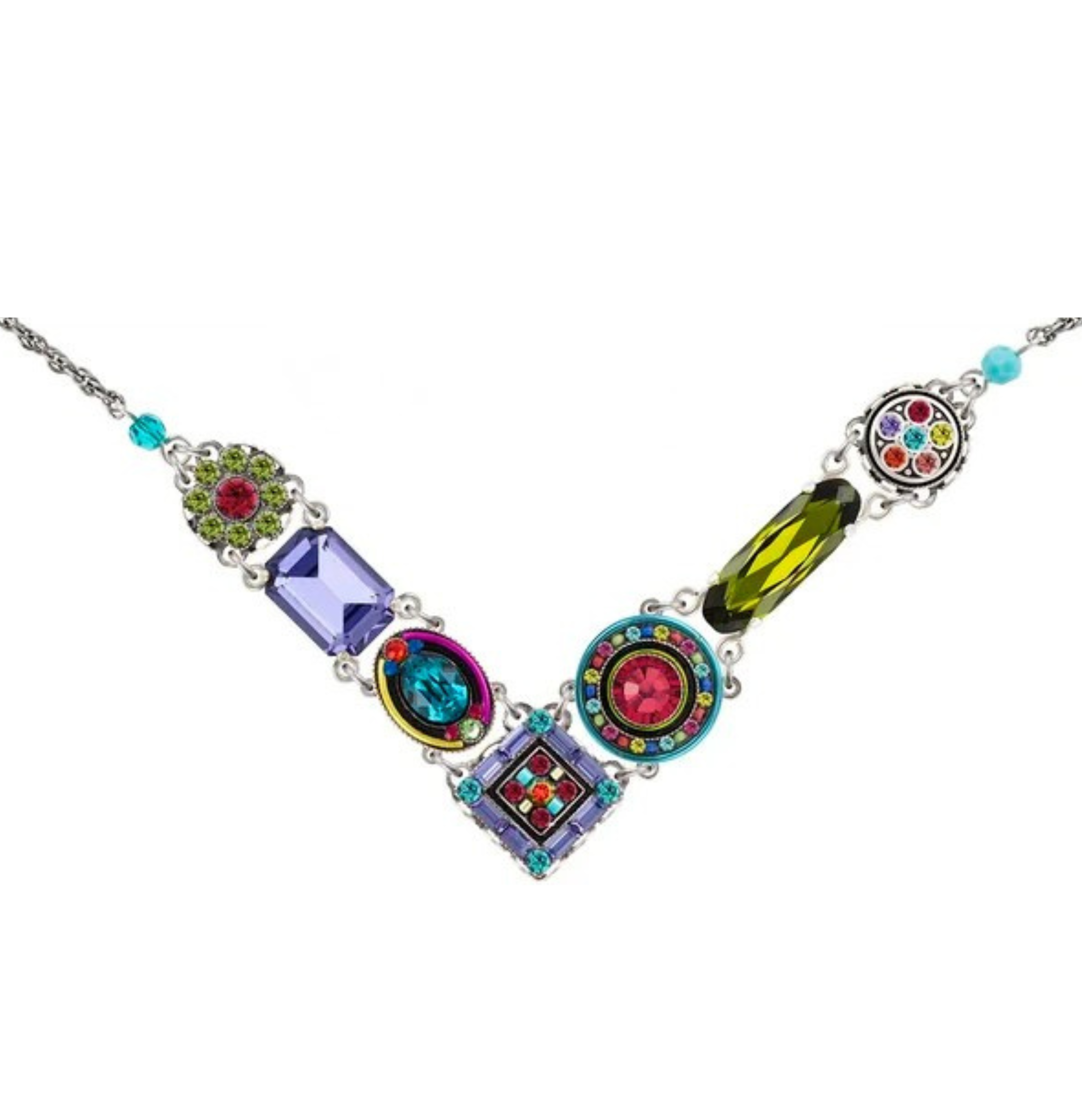 Introducing the La Dolce Vita "V" Multi-Color Necklace by Firefly—a fair-trade jewelry piece handmade in Guatemala. This chic necklace showcases an array of geometric, gemstone-inspired shapes in vibrant green, purple, blue, red, and yellow hues arranged along a silver chain to form a signature V-shape, blending bold style with ethical craftsmanship.