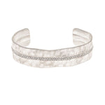 The A-Train Silver Crystal Row Cuff Bracelet features a matte, textured finish and a central row of sparkling stones, with an adjustable cuff design for a comfortable, stylish fit.