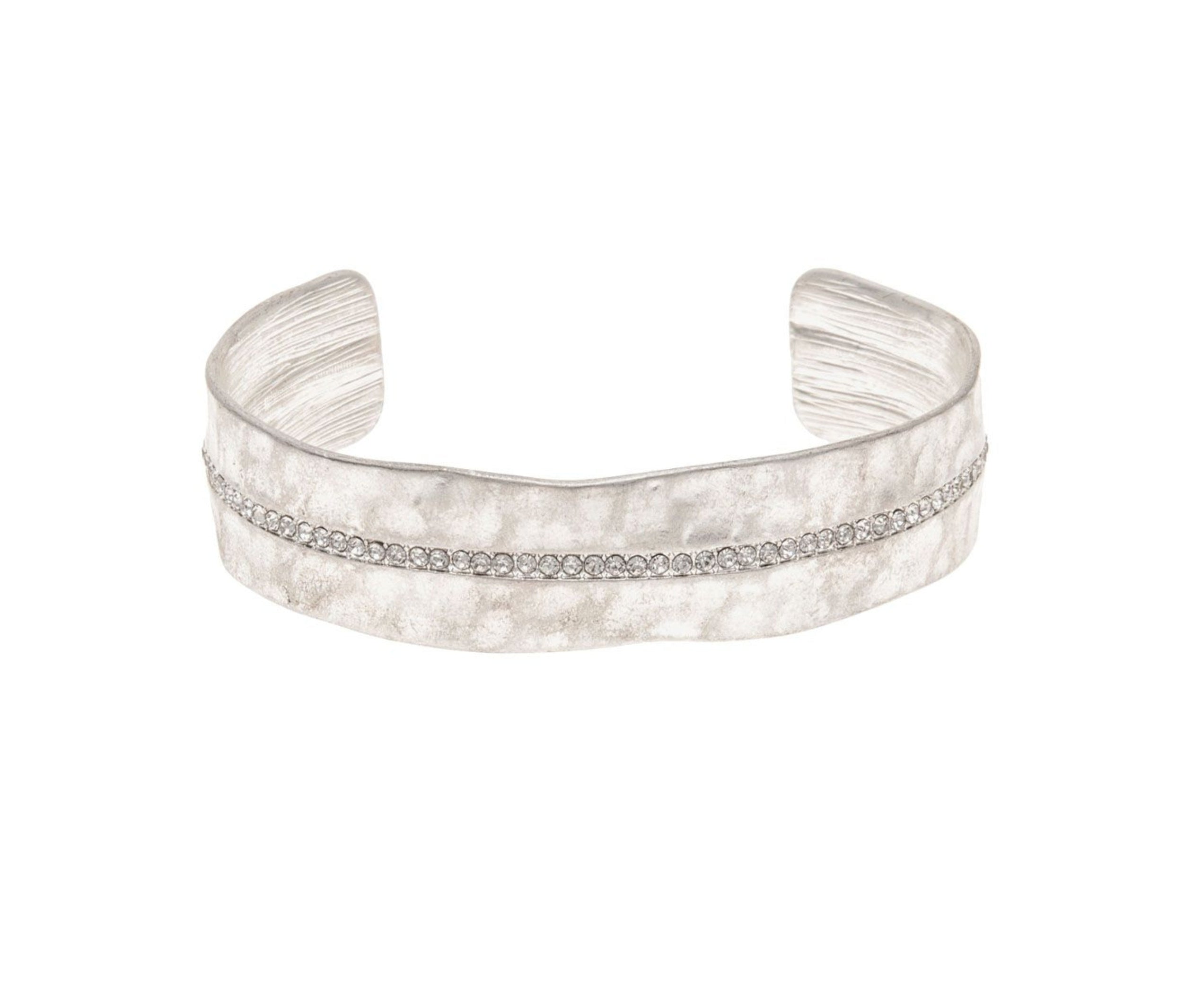 The A-Train Silver Crystal Row Cuff Bracelet features a matte, textured finish and a central row of sparkling stones, with an adjustable cuff design for a comfortable, stylish fit.