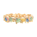 The A-Train Gold Multi-Color Turtles and Shells Beach Bracelet features jeweled blue, green, and pink accents on high-quality metal turtles, linked in a continuous design and shown on a white background.
