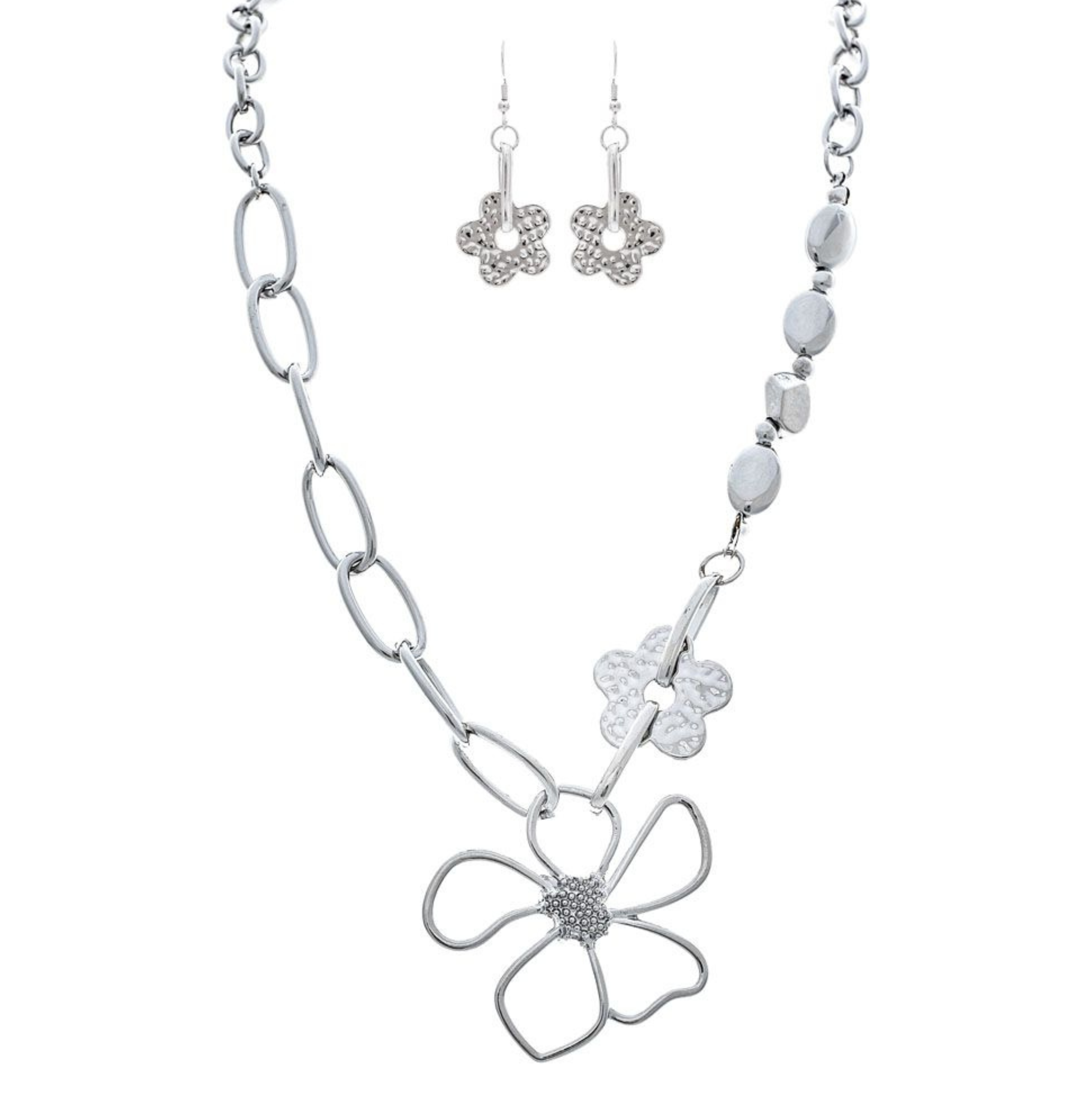 The A-Train Silver Flower Chain Link Necklace Set includes a necklace and dangle earrings with large chain links, a wire-style flower pendant, and a textured flower charm, all crafted from mixed jeweler’s metals.