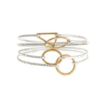 The A-Train Two-Toned 4 Piece Hook Bangle Set Bracelet features mixed metals and gold-toned accents, offering a unique and striking look with its layered design.