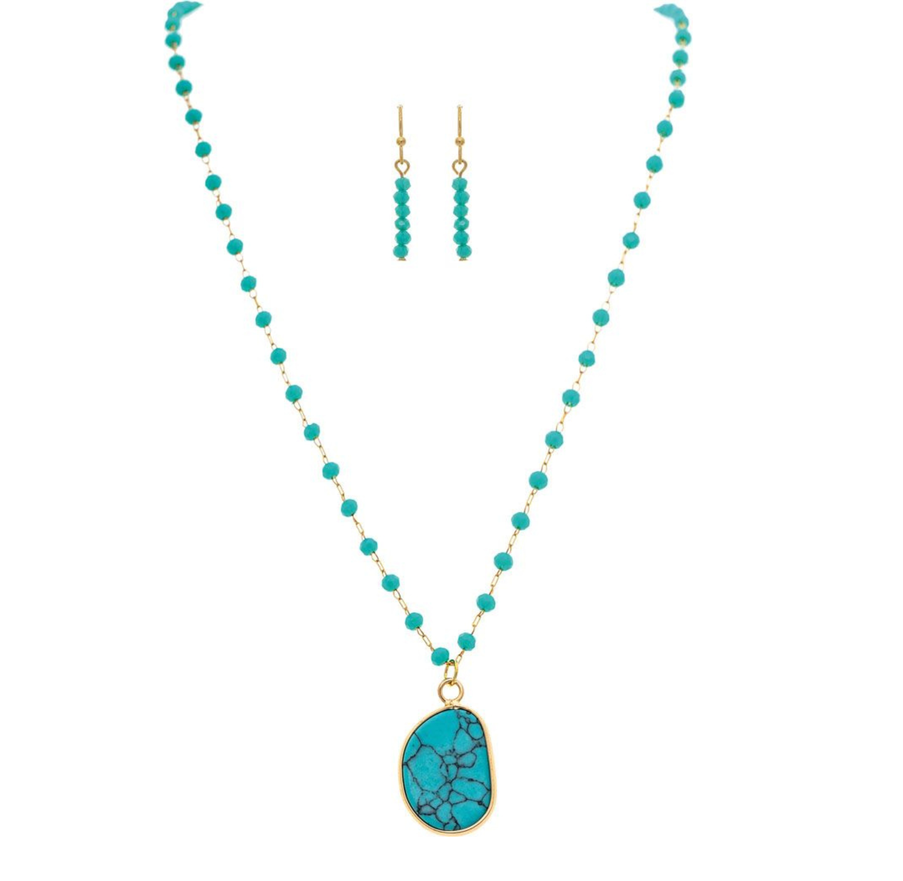 The A-Train Gold Blue Bead Chain Turquoise Pendant Necklace Set features a turquoise pendant necklace and matching bead drop earrings, shown on a white background.
