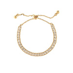 The A-Train Gold Crystal Row Slide Clasp Bracelet features two rows of sparkling clear stones and an adjustable sliding clasp with gold bead ends—an elegant accessory for any occasion.