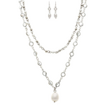The A-Train Silver Mix FW/Faux Pearl Crystal Necklace Set includes two layered chains with clear gems, small pearls, a large faux pearl pendant, and matching dangle earrings with oval pearls, all shown on a white background.